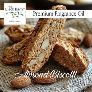 May include: Close-up of almond biscotti, a baked Italian cookie, with visible almond pieces. The image includes the text "Premium Fragrance Oil" and "Almond Biscotti". The Black Barn logo is in the upper left corner.