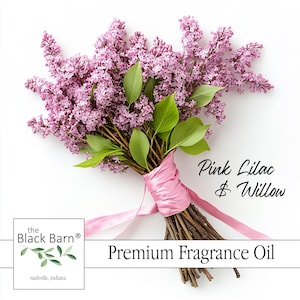 May include: A bouquet of pink lilacs and green leaves tied with a pink ribbon. The text "Pink Lilac & Willow" is displayed. The product is "Premium Fragrance Oil" from the Black Barn.