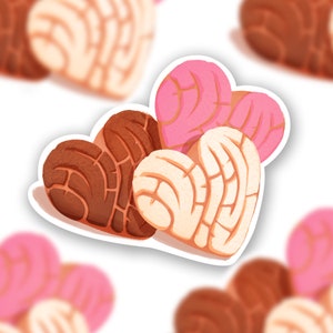 May include: Three heart-shaped pastries, one brown, one white, and one pink, with a swirl pattern.