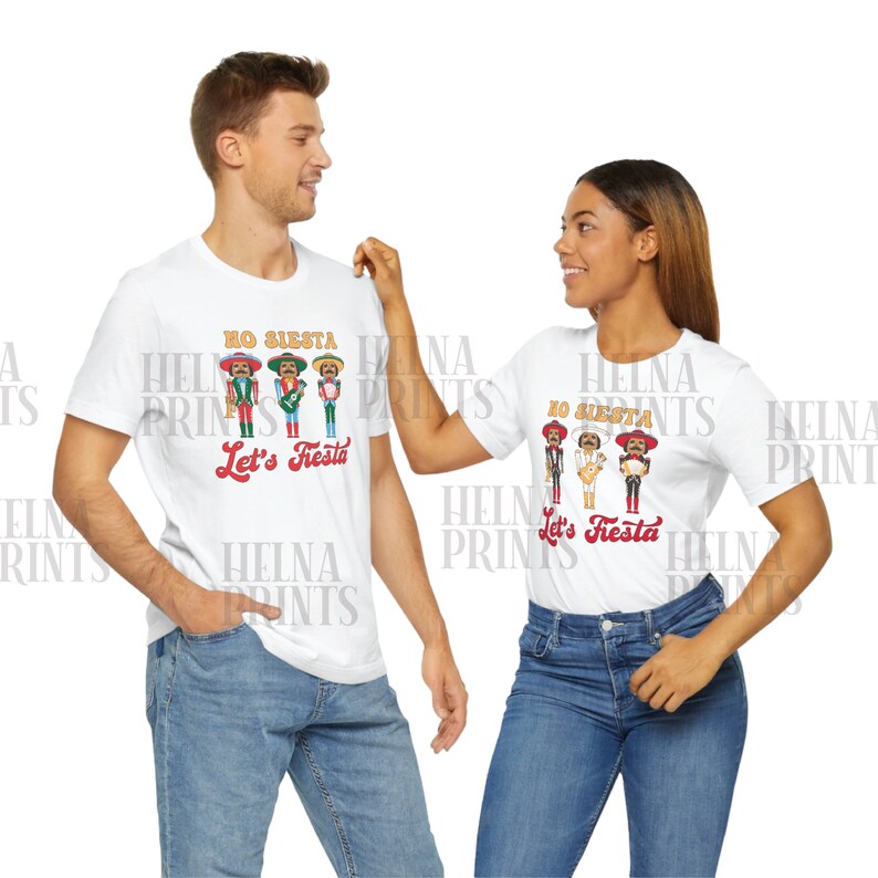 May include: Two white t-shirts with a graphic of three cartoon mariachi musicians playing instruments. The text on the shirts reads "No Siesta Let's Fiesta".