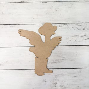 May include: A wooden cutout of a cowboy chicken wearing a hat and boots. The cutout is brown and has a rustic look.
