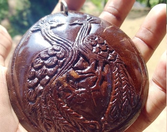 Beautiful handmade coconut shell key tags with beautiful couple of peacocks.