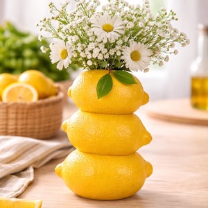 May include: A handmade wooden sign with the text "Welcome" in a handwritten style. The sign is painted white with a distressed finish, and a small green leaf is attached to the top. The sign is designed for home decor.