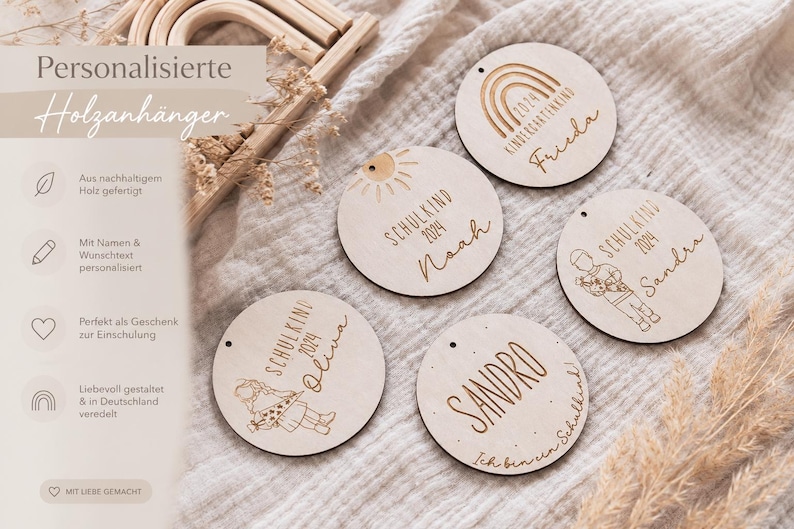 May include: Wooden round ornaments with engraved names and the year 2024. The ornaments feature illustrations of a rainbow, sun, and children. Text on the ornaments includes "Kindergartenkind", "Schulkind", and names like "Frieda", "Noah", "Sandra", "Oliva", and "Sandro".