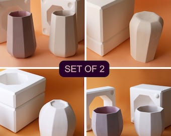 May include: Set of two ceramic molds for making geometric candle holders. The molds are white and the candle holders are shown in both white and a light purple color. The molds are square with a round opening in the top. The candle holders are geometric with a rounded top.