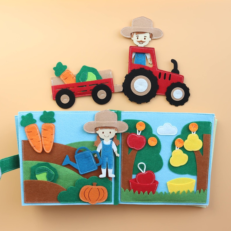 May include: A felt book for children featuring a red tractor, a farmer, a girl, and various farm animals. The book has a blue background and is made of felt.