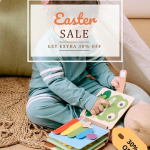 May include: A child in a teal sweatsuit plays with a colorful felt book. The book has rainbow-colored shapes and a green frog design. The image includes the text "Easter SALE" and "GET EXTRA 30% OFF" on a white background.