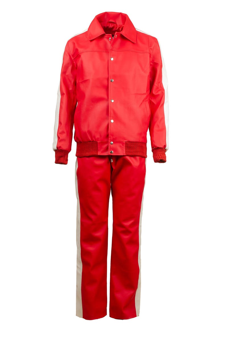 May include: A red tracksuit with white stripes down the sleeves and legs. The jacket has a collar, snap closures, and a ribbed hem and cuffs. The pants have a matching red and white stripe design.