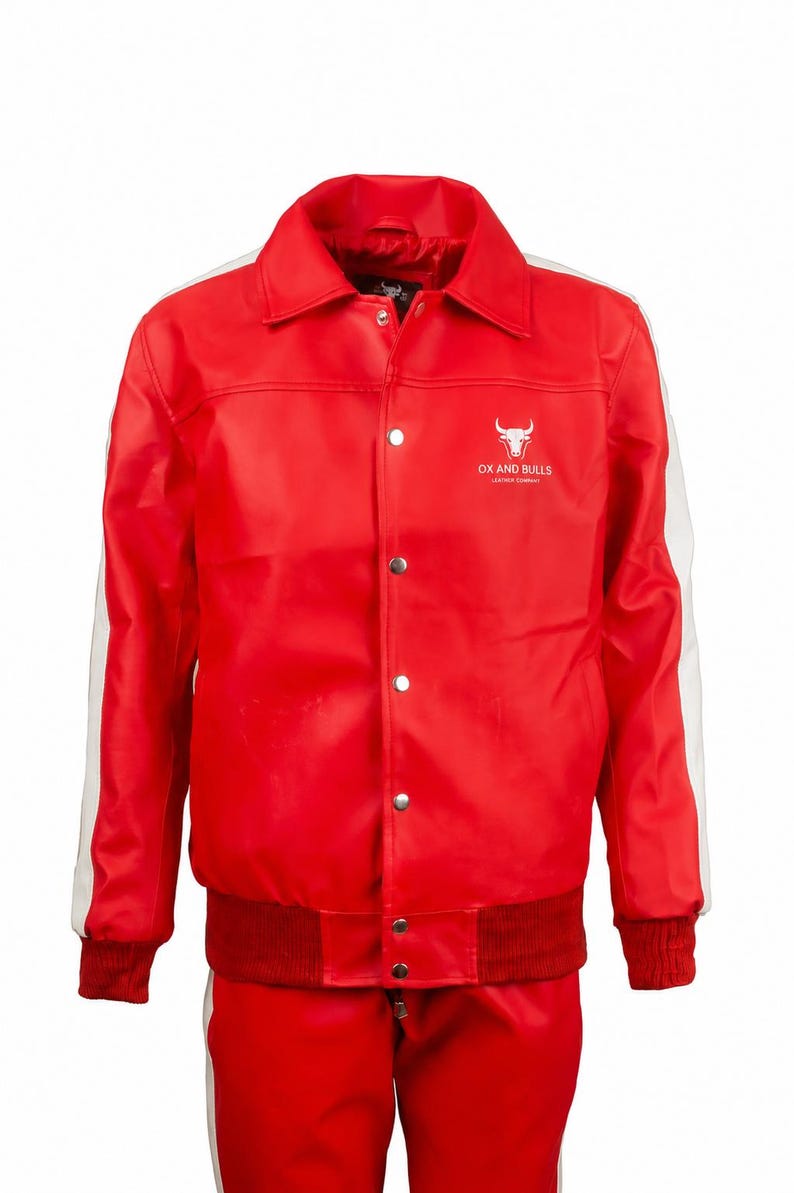 May include: A red jacket with white stripes on the sleeves and a matching red ribbed hem and cuffs. The jacket has a button-up front and a white logo with a bull's head and the text "OX AND BULLS LEATHER COMPANY".
