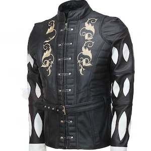 May include: A black leather jacket with a gold embroidered design on the front and white diamond-shaped panels on the sleeves. The jacket has a high collar and a belt.