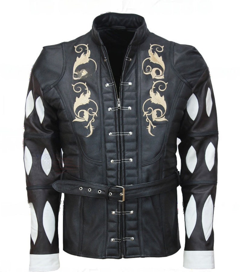 May include: A black leather jacket with a high collar and a zipper closure. The jacket has a belt and decorative stitching. The sleeves have white diamond-shaped patches.