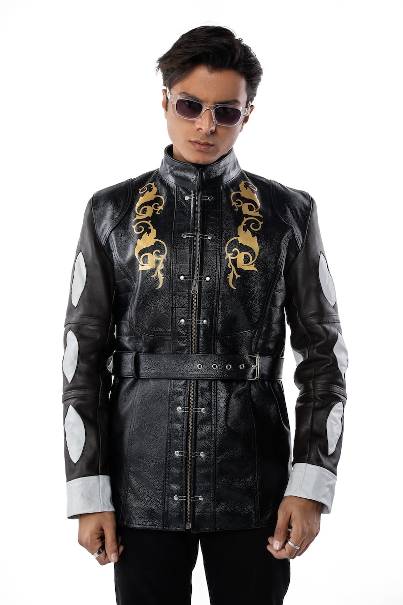 May include: A black leather jacket with gold embroidery and a belt. The jacket has a zipper closure and a stand-up collar.
