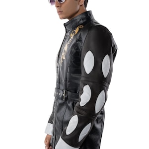 May include: A black leather jacket with white and brown accents. The jacket has a gold embroidered design on the front and a belt at the waist.