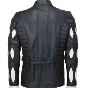 May include: Black leather jacket with white diamond-shaped panels on the sleeves. The jacket has a belt and a stand-up collar.