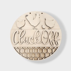 May include: A round wooden sign with the text "Cluck Off" in a decorative font. The sign features a rooster and three chickens, and a chicken wire pattern at the bottom.