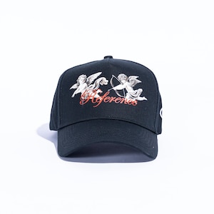 May include: Black baseball cap featuring a graphic of two cherubs with bows and arrows, and the word "References" in red script. The cap has a curved brim and a structured crown, suitable for casual wear.