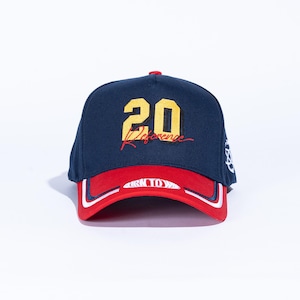 May include: Navy blue baseball cap with a red brim and white trim. The cap features the number "20" in yellow with a black outline, and the word "Reference" in red script. A small logo is on the side.