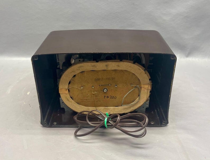 K&ouml;nnte beinhalten: Ein braunes Vintage-Radio mit einem runden Lautsprechergitter und einem Etikett mit der Aufschrift "F6-330".