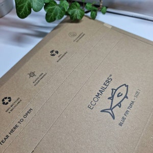 May include: A brown paper mailing envelope with the text "ECOMAILERS" and a blue fin tuna illustration. The envelope is made from 100% recycled and recyclable materials. It is plastic free and ocean friendly. The envelope has a tear here to open tab.
