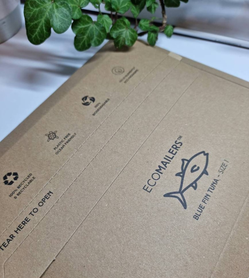 May include: A brown paper mailing envelope with the text "ECOMAILERS" and a blue fin tuna illustration. The envelope is made from 100% recycled and recyclable materials. It is plastic free and ocean friendly. The envelope has a tear here to open tab.