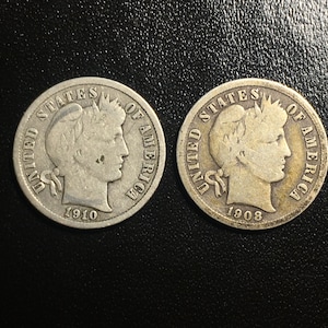 May include: Two silver US dimes, one from 1908 and one from 1910, showing the profile of Liberty on the obverse.