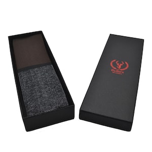 May include: A black box with a brown and gray patterned tie inside. The box has the text "Butlers of London" printed on it.