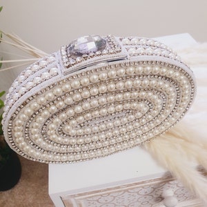 A beautiful clutch bag/purse made of pearls and diamonds. One of our best sellers!