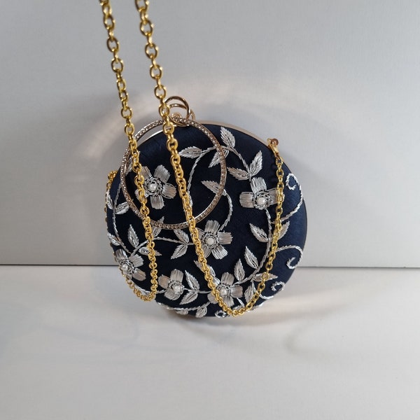 Navy blue round clutch purse collection with silver embroidery, gold casing and chain.