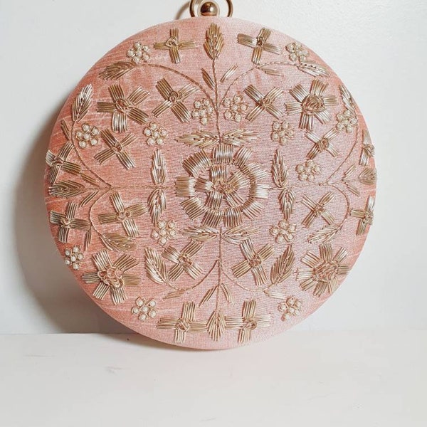 Unique round bag with detachable chain. A peach pink with stitched gold embroidery! Available in 5 colours.