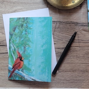Tarjeta navideña con cardenal plegado Tarjeta navideña nórdica Ilustración escandinava Tarjeta de felicitación navideña acogedora Invierno