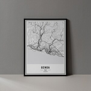 May include: Black and white line art map print of Genoa, Italy in a black frame. The print has the text "GENOA" and "ITALY" in a minimalist font.