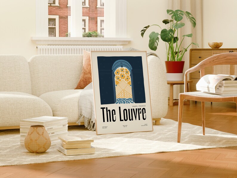 May include: A framed poster with a blue and yellow illustration of an archway with the text "The Louvre, Paris, France" printed below.
