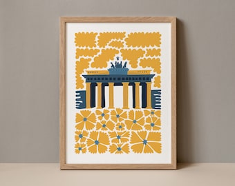 May include: A framed print of a stylized illustration of the Brandenburg Gate in Berlin, Germany. The gate is depicted in blue and yellow, with a field of yellow flowers in the foreground.