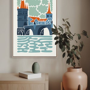 May include: A colourful illustration of a bridge with a tower and a church in the background. The bridge is blue and grey, the tower is orange and grey, and the church is orange and blue. The background is white with green clouds.