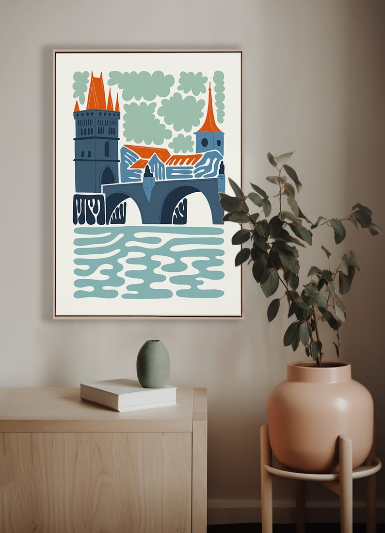 May include: A colourful illustration of a bridge with a tower and a church in the background. The bridge is blue and grey, the tower is orange and grey, and the church is orange and blue. The background is white with green clouds.