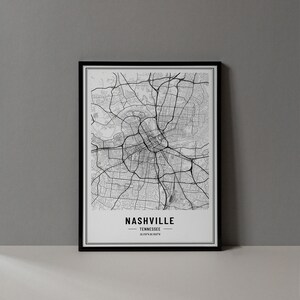 May include: Black and white map print of Nashville, Tennessee with the city name and coordinates in the bottom right corner. The map is framed in a black frame.