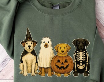 May include: Green sweatshirt featuring a Halloween-themed graphic of four dogs dressed in costumes: a witch, a ghost, a pumpkin, and a skeleton. The graphic is centered on the front of the sweatshirt. The sweatshirt has long sleeves and a crew neck.