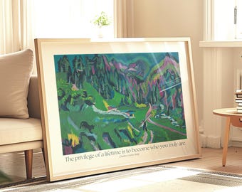 May include: A framed art print featuring a colorful landscape painting with green, purple, and blue hues. The artwork is displayed in a light-colored wooden frame and leans against a wall. The text at the bottom reads: "The privilege of a lifetime is to become who you truly are."