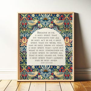 May include: Framed artwork featuring a quote by Saint Augustine, set against a detailed floral and bird pattern in blue, green, red, and yellow. The text is in a white arched frame, and the wooden frame adds a natural touch.