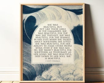 May include: A wooden framed print with a quote by F. Scott Fitzgerald, set against a backdrop of swirling blue and white abstract art. The quote reads, "She was beautiful...deep down to her soul she is beautiful."