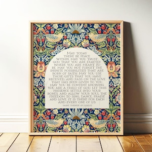 May include: A framed print with a wooden frame. The artwork features a floral and bird pattern in blue, green, red, and yellow. The text within the frame reads "May Today There Be Peace Within..." and is attributed to Saint Therese of Lisieux.