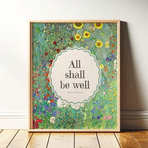 May include: Framed art print featuring a floral landscape with sunflowers and various wildflowers. The artwork includes the text "All shall be well" in a decorative, scalloped-edge circle. The frame is a light wood color.