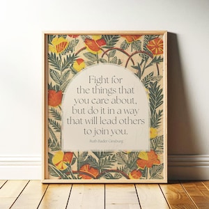 May include: Framed art print featuring a quote by Ruth Bader Ginsburg: "Fight for the things that you care about, but do it in a way that will lead others to join you." The artwork has a floral design with orange, yellow, and green elements.