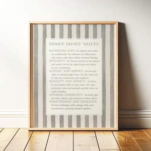 May include: A framed wall art print featuring the text BISHOP FAMILY VALUES followed by a list of principles including Boundless Love, Integrity, Support and Service, Humility and Respect, Offering Generosity, and Perseverance and Resilience.