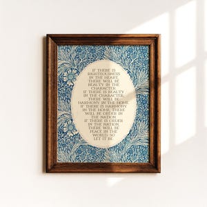 May include: A framed print with a brown wooden frame. The print features a blue and white floral pattern surrounding an oval shape with text. The text reads, "If there is righteousness in the heart..." and continues with a message about harmony and peace.