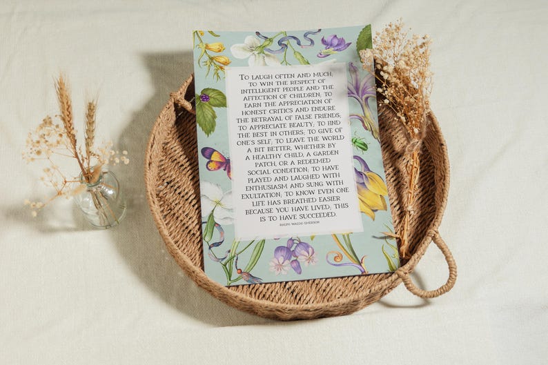 Print of Ralph Waldo Emerson Success poem written in a white center rectangle, surrounded by a background of light blue with vintage floral artwork. Pictured as fine art print.