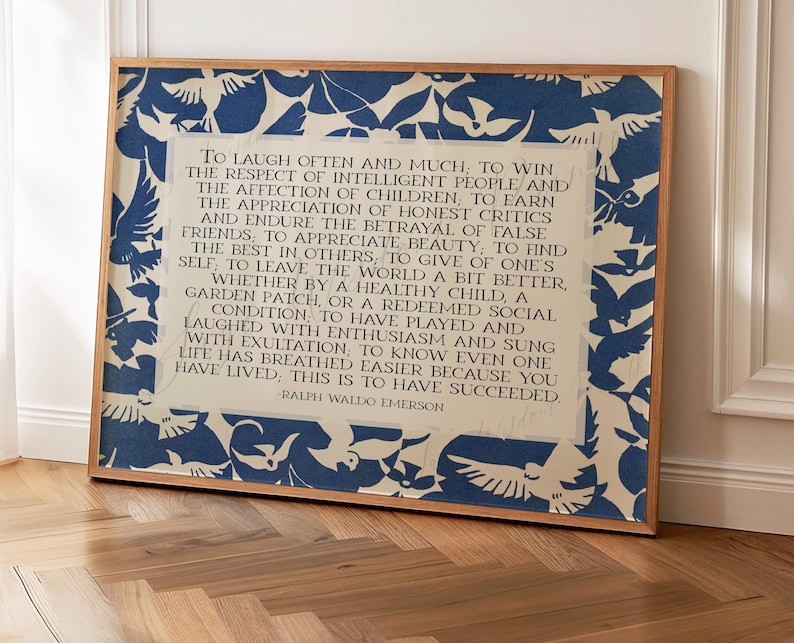 May include: A framed print featuring a quote by Ralph Waldo Emerson. The print has a light beige background with a blue and white bird pattern border. The quote is in black text.