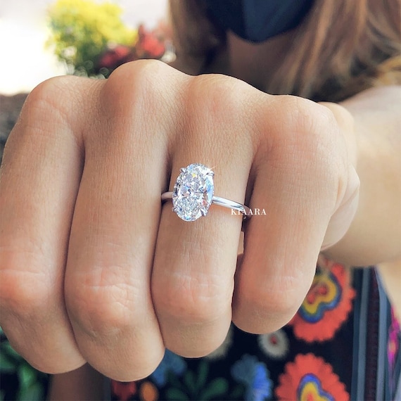 Oval moissanite engagement ring with pave diamond band and hidden halo 8x6mm