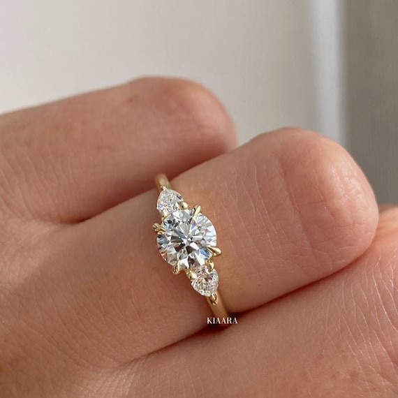 14k White Gold 3-Stone Round and Pear Moissanite Engagement Ring 14k White Gold 3-Stone Round and Pear Moissanite Engagement Ring