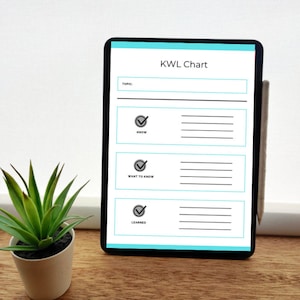 May include: A digital tablet displaying a KWL Chart template with sections labeled Know, Want to Know, and Learned, each featuring a checkmark icon and horizontal lines for writing, accompanied by a stylus attached to the side of the device.